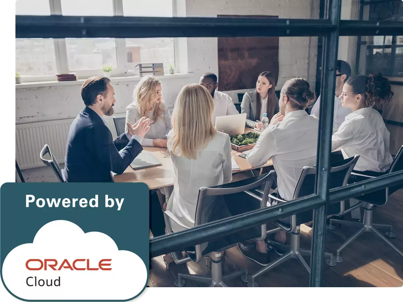 Group of people sitting around a conference table behind glass; Powered by Oracle Cloud logo