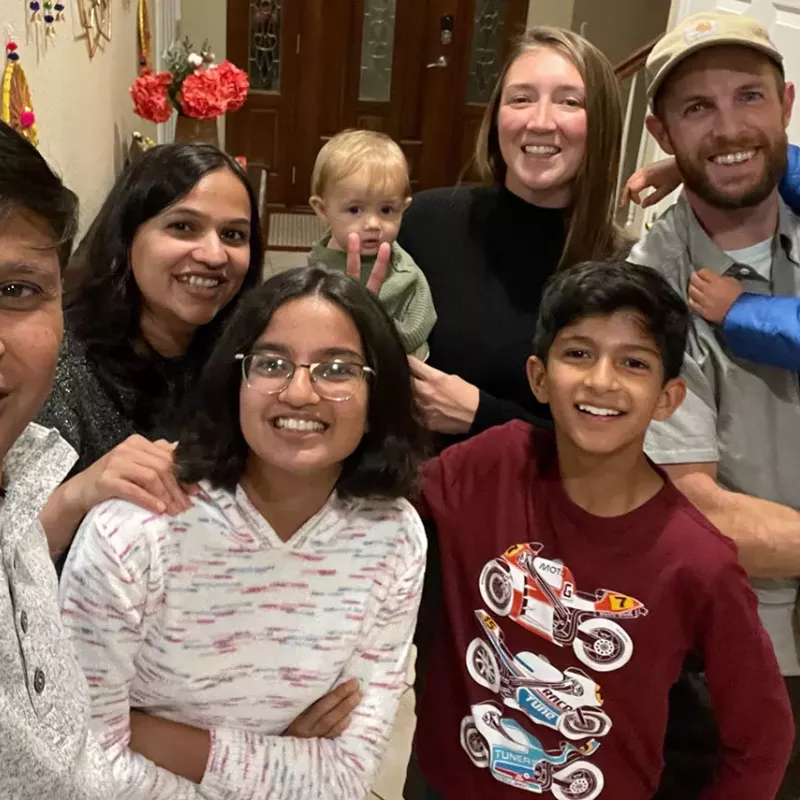 Xactly families taking a selfie in a home entryway as part of the CAREgivers Affinity Group