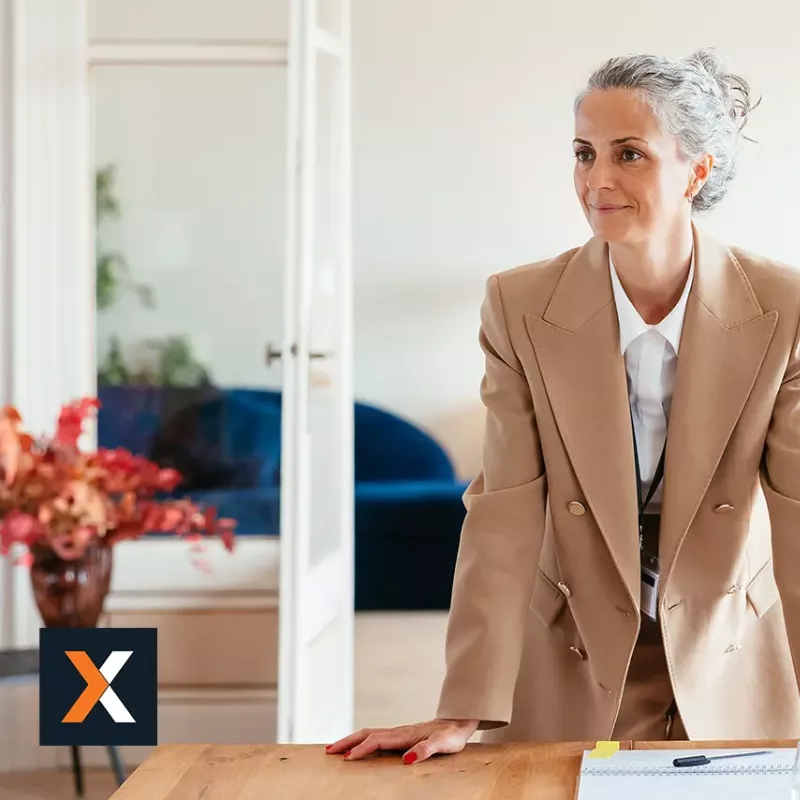 Woman in business suit standing smiling 