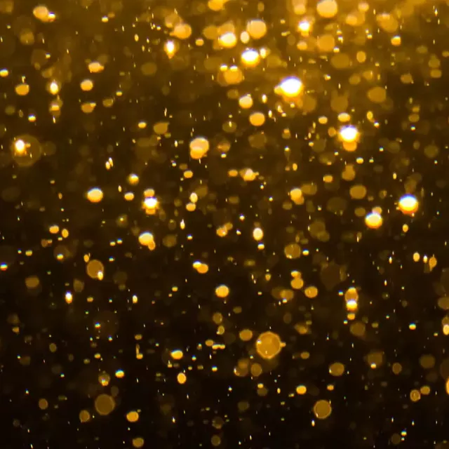 Golden confetti background on black