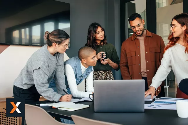 a group of coworkers gathered around a conference table working together