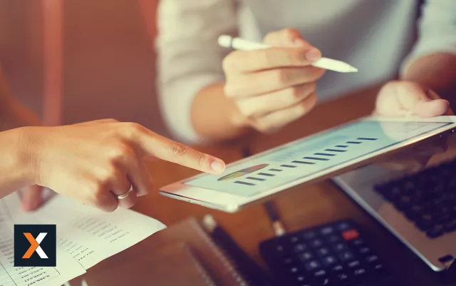 woman working on tablet with bar graphs