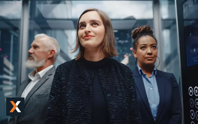 woman in business attire standing next to a male and female business professional
