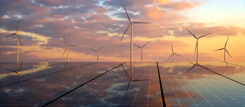 Solar panels and modern windmills during a sunset; Environmental Social Governance at Xactly